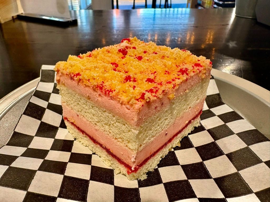 Slice of layer cake on checkered paper