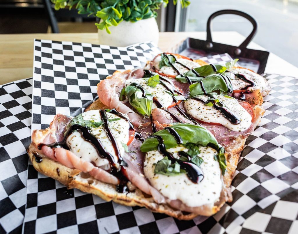 Focaccia pizzetta with prosciutto, fresh mozzarella and balsamic glaze