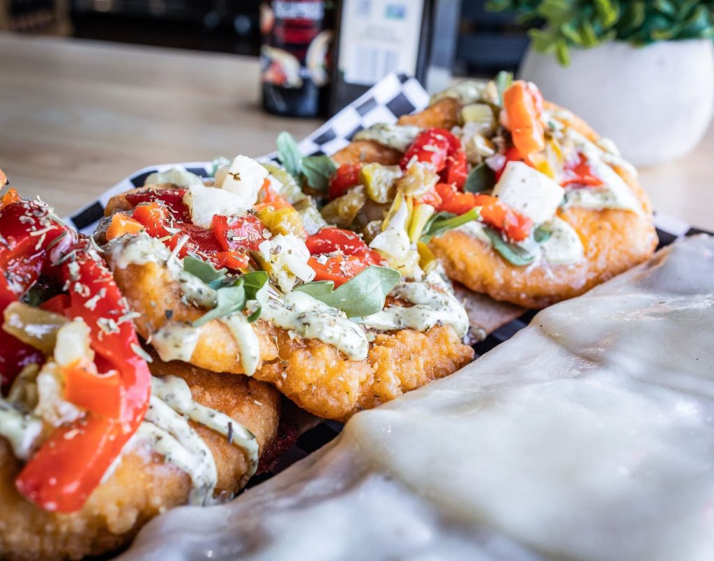 Pizzettas topped with roasted peppers and mozzarella