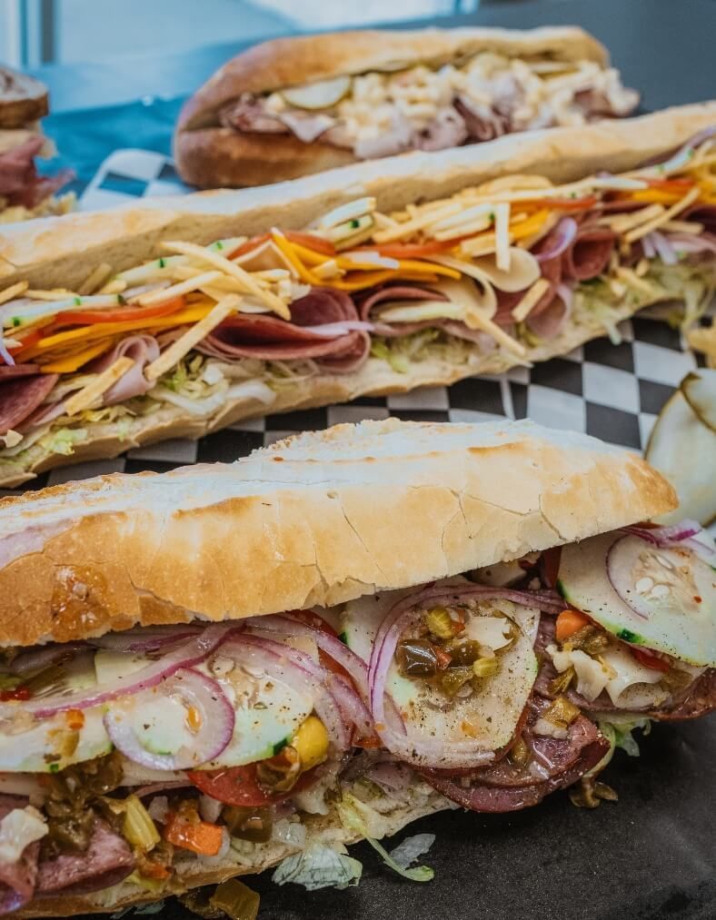 Two subs stacked on checkered paper